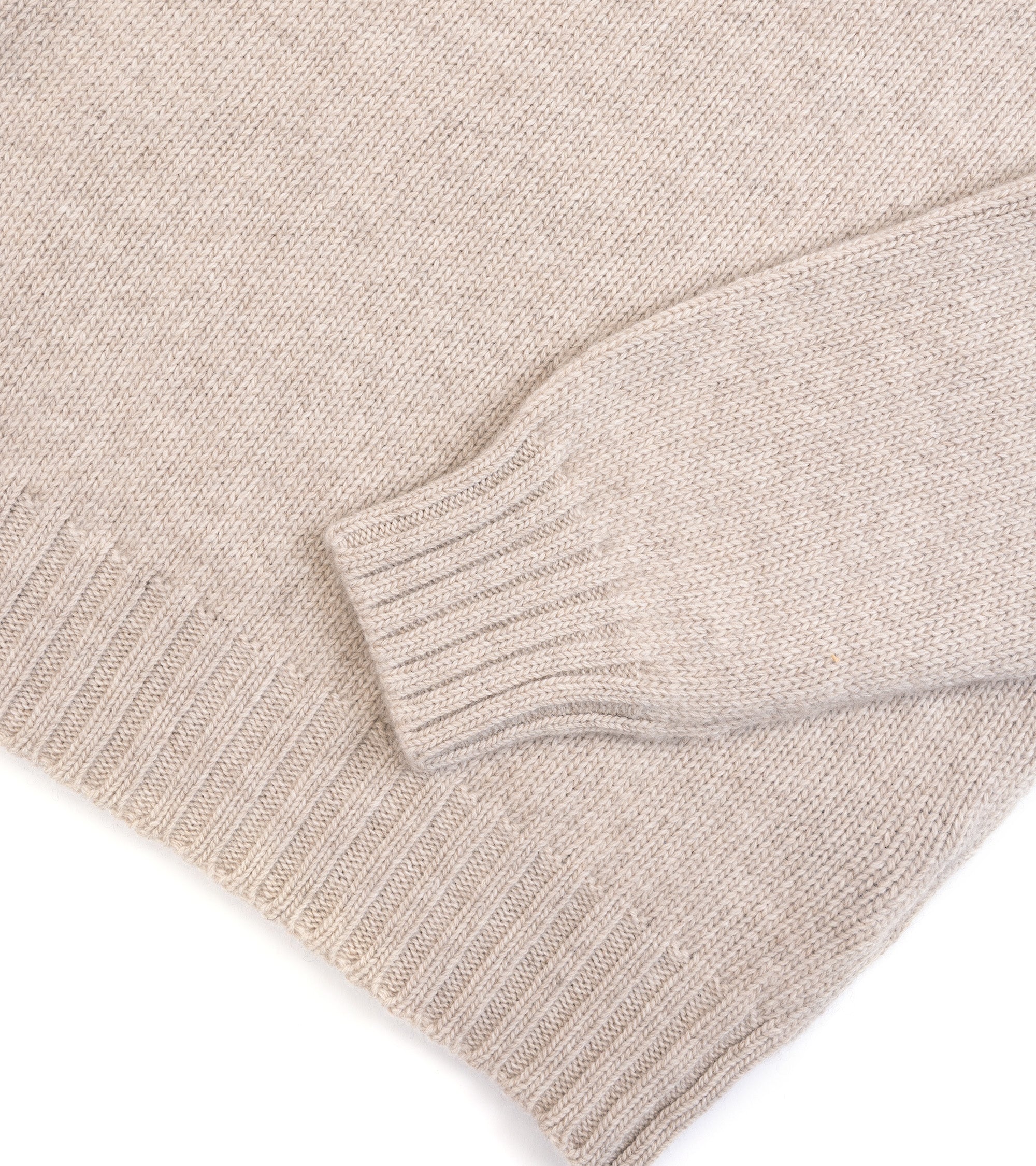 Fedeli Oslo Wool Cashmere Roll Neck Sweater in a light beige melange, close-up detail of the ribbed hemmed and sleeve.