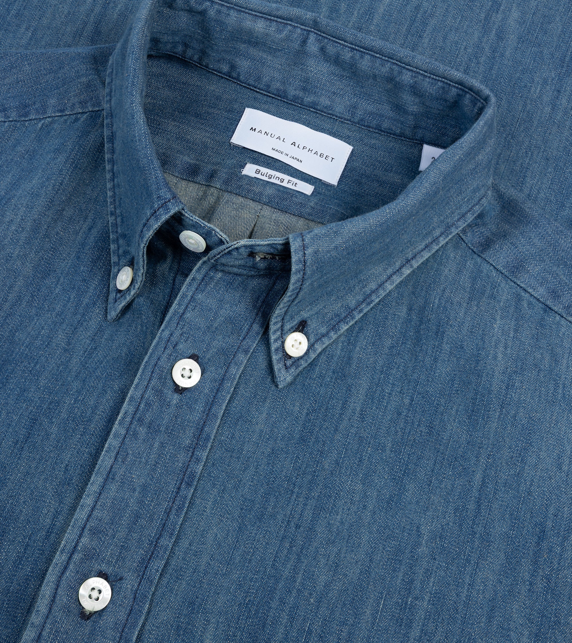 Manual Alphabet button-down shirt in navy 6oz Japanese denim, fabric detail of the denim.