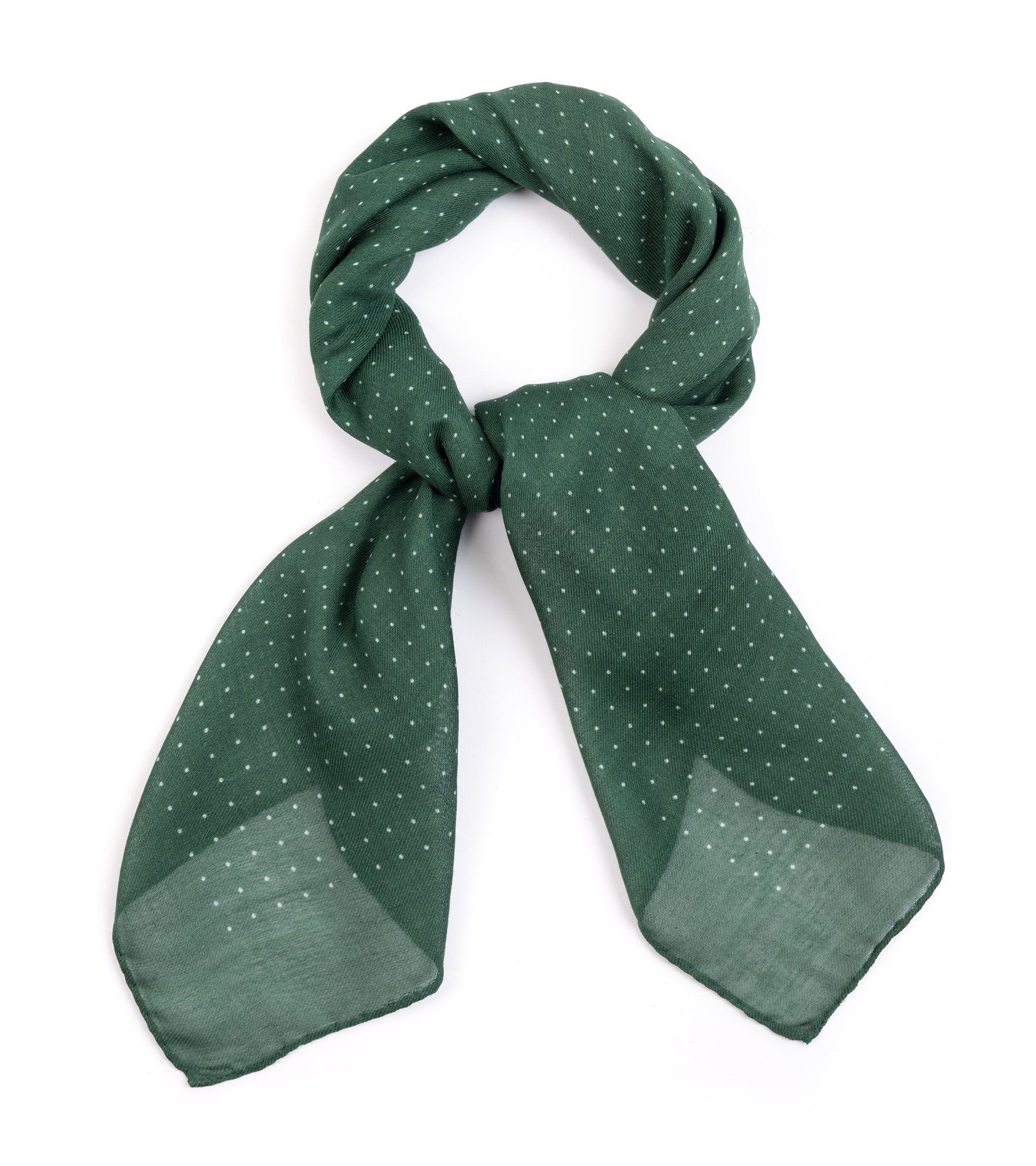 A green scarf with a delicate white polka dot pattern, styled in a loop with two hanging ends on a plain white background.