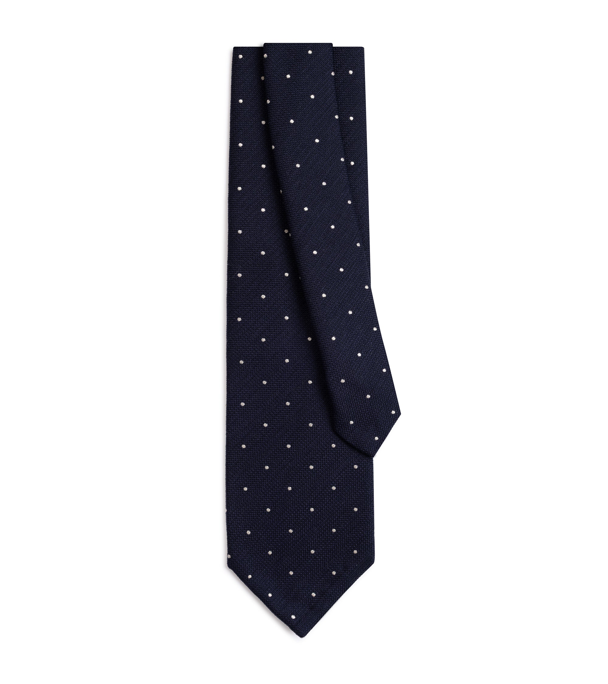 A dark navy blue necktie with a small white polka dot pattern, neatly folded and displayed against a solid white background.