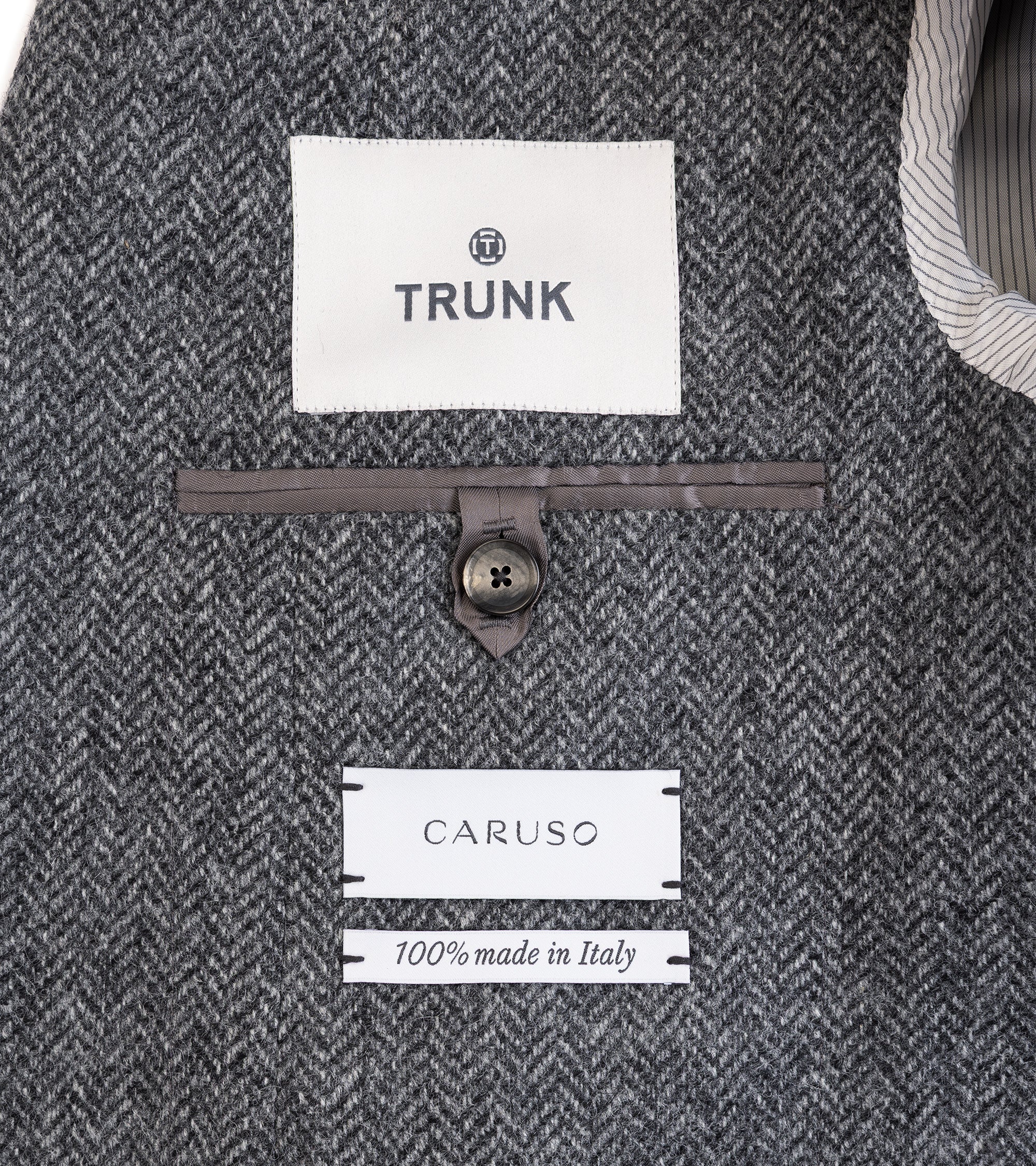 Caruso Aida jacket in grey Shetland wool herringbone, fabric texture close-up.